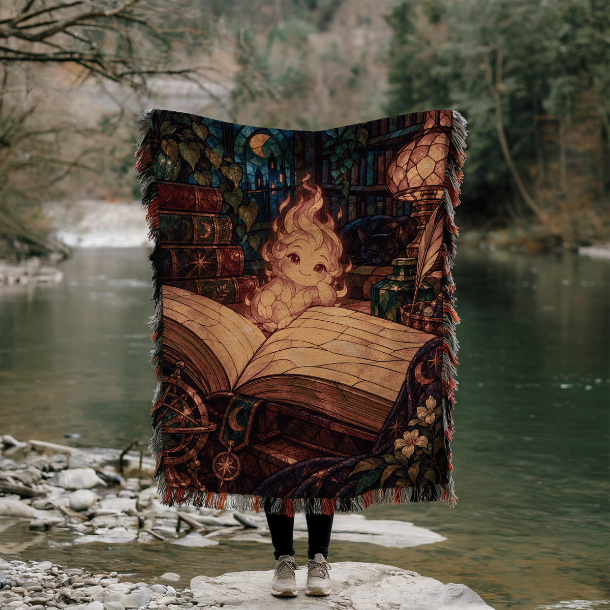 Ember Woven Throw Blanket held up outdoors by a river