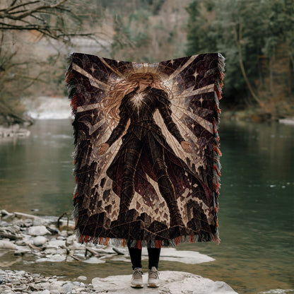 Asterin's Yielding Woven Throw Blanket held up outdoors by a river