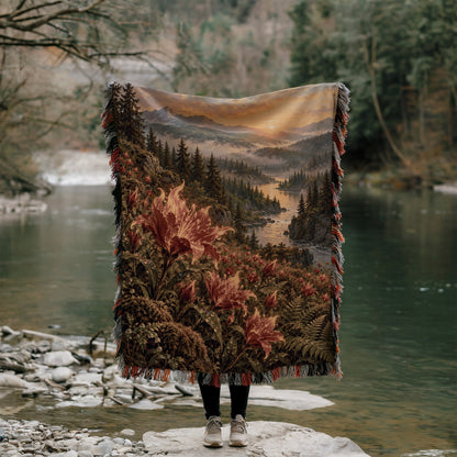 Kingsflame Woven Throw Blanket held up outdoors by a river