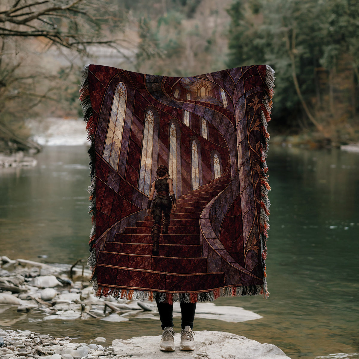 Nesta's Staircase Woven Throw Blanket held up outdoors by a river