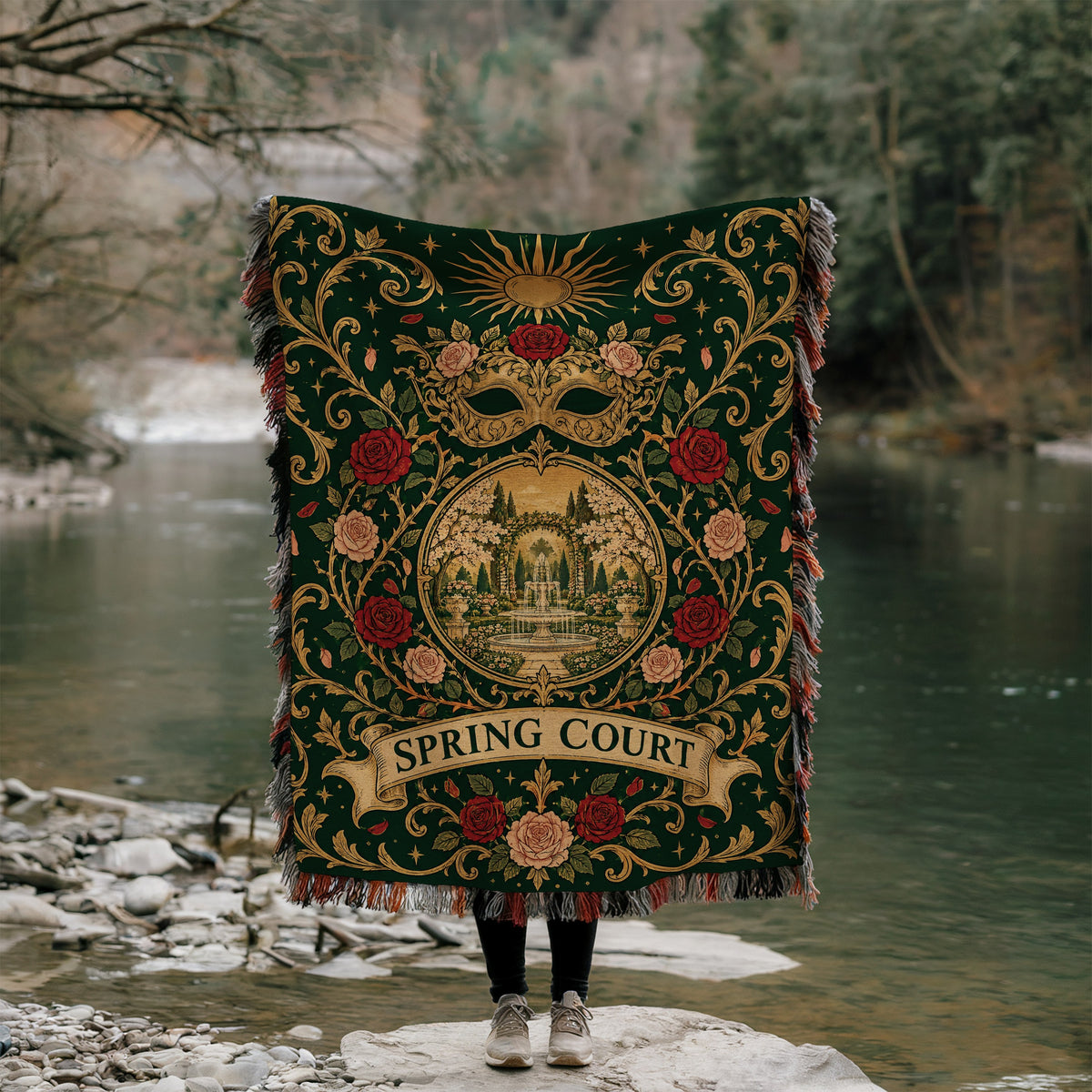 Spring Court Masquerade Crest Woven Throw Blanket held up by a river