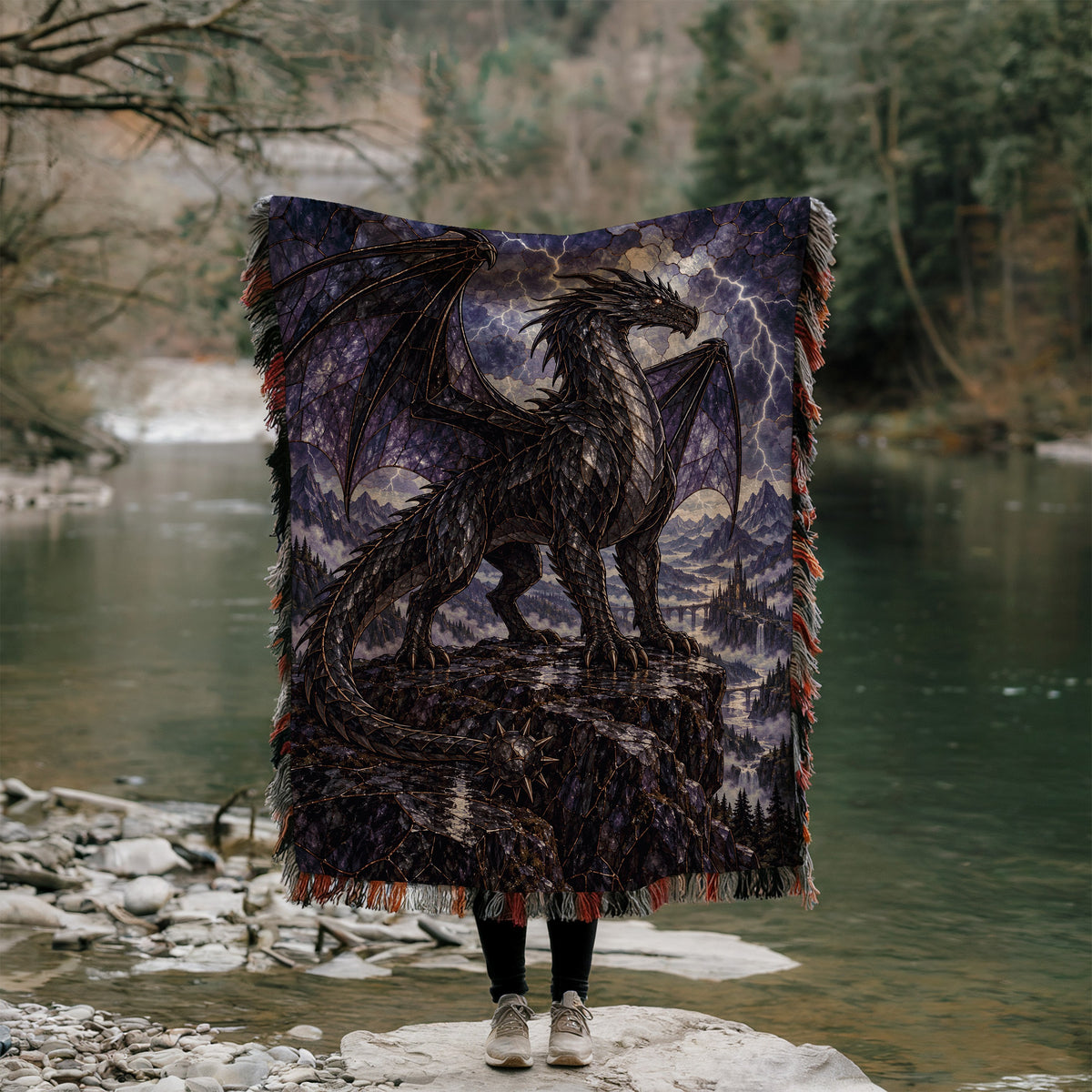 Storm Tairn Woven Throw Blanket held up outdoors by a river