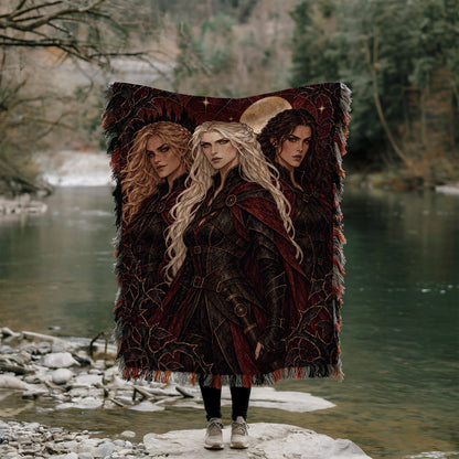 Ice, Fire, and Stone Woven Throw Blanket held up outdoors by a river