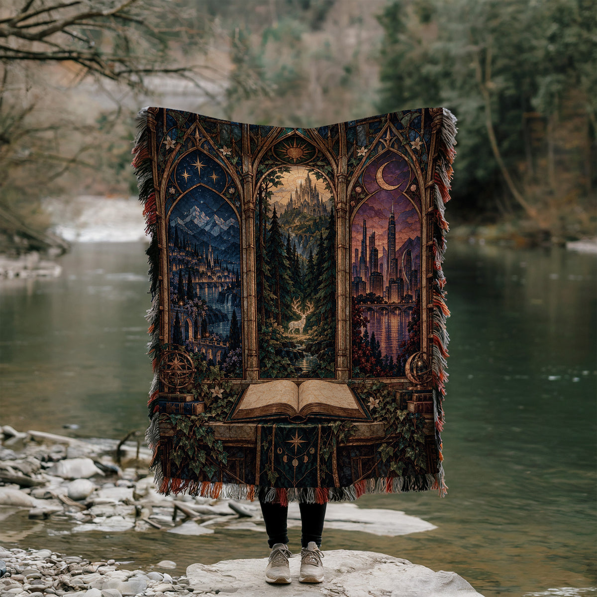 Maasverse Realms Woven Throw Blanket held up outdoors by a river