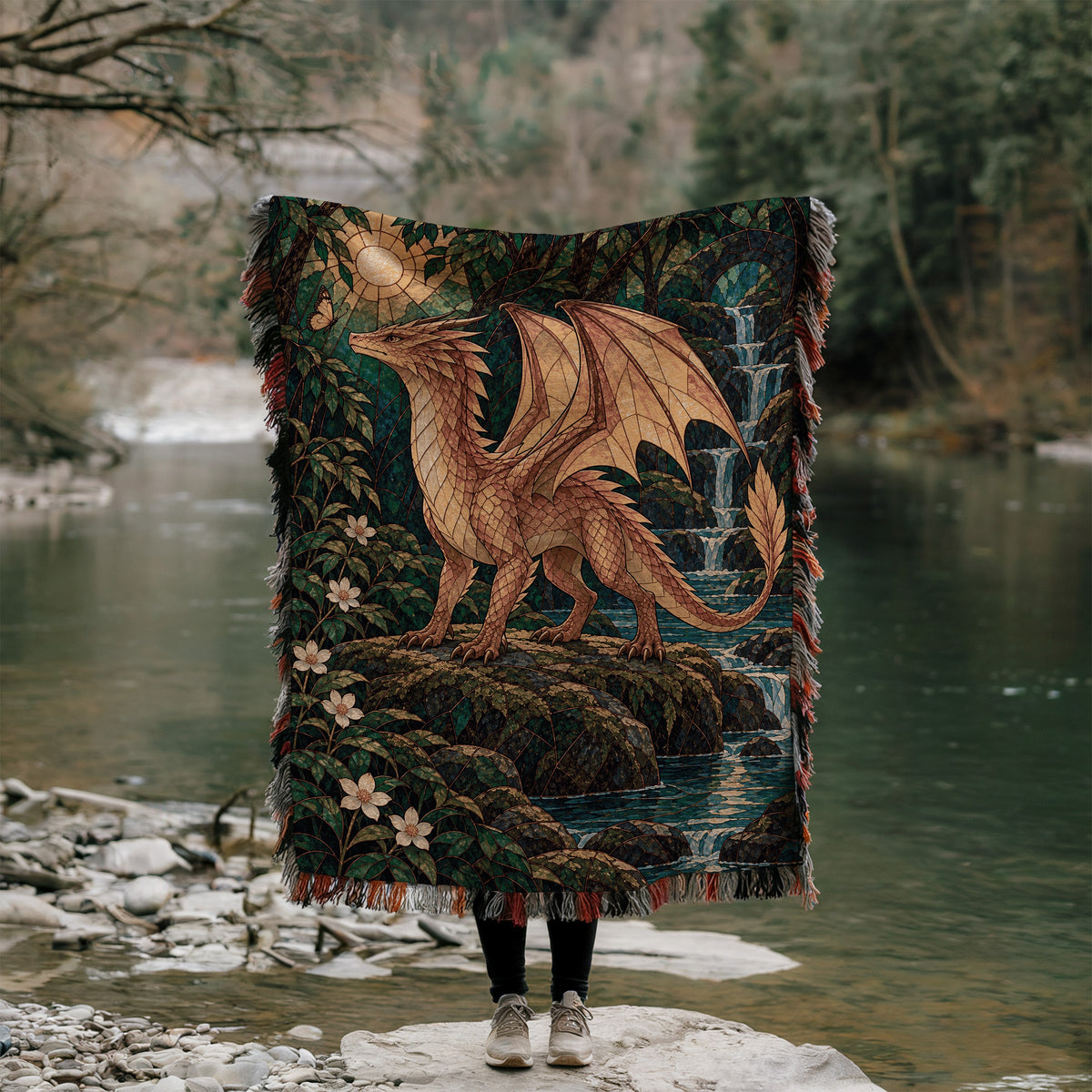 Gold Andarna Woven Throw Blanket held up outdoors by a river
