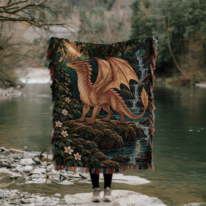 Gold Andarna Woven Throw Blanket held up outdoors by a river