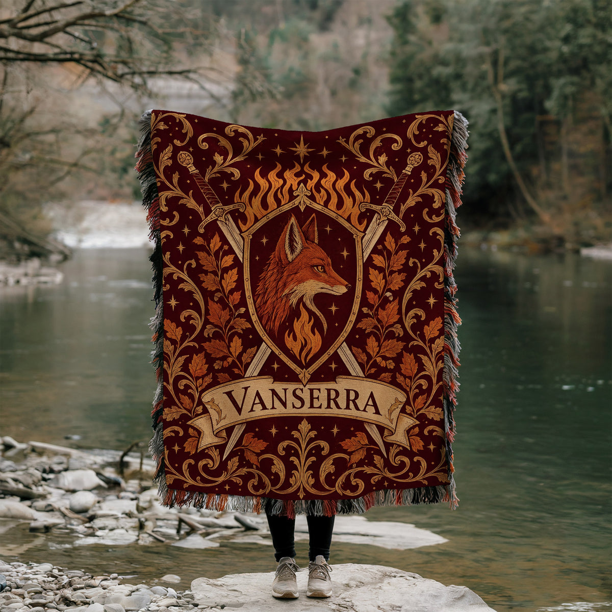 Vanserra Crest Woven Throw Blanket held up by a river