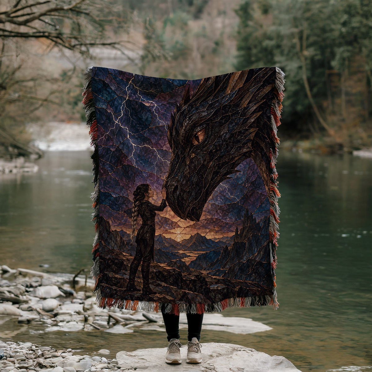 Dragon Rider Woven Throw Blanket held up outdoors by a river