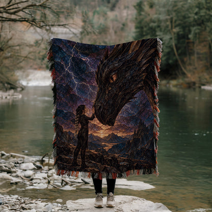 Dragon Rider Woven Throw Blanket held up outdoors by a river