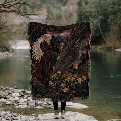 Wildflower Truce Woven Throw Blanket held up outdoors by a river
