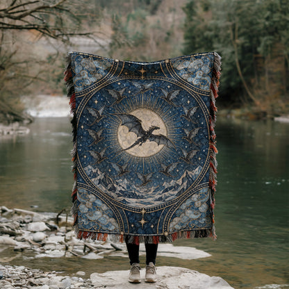 The Thirteen Stained Glass Woven Throw Blanket held up by a river