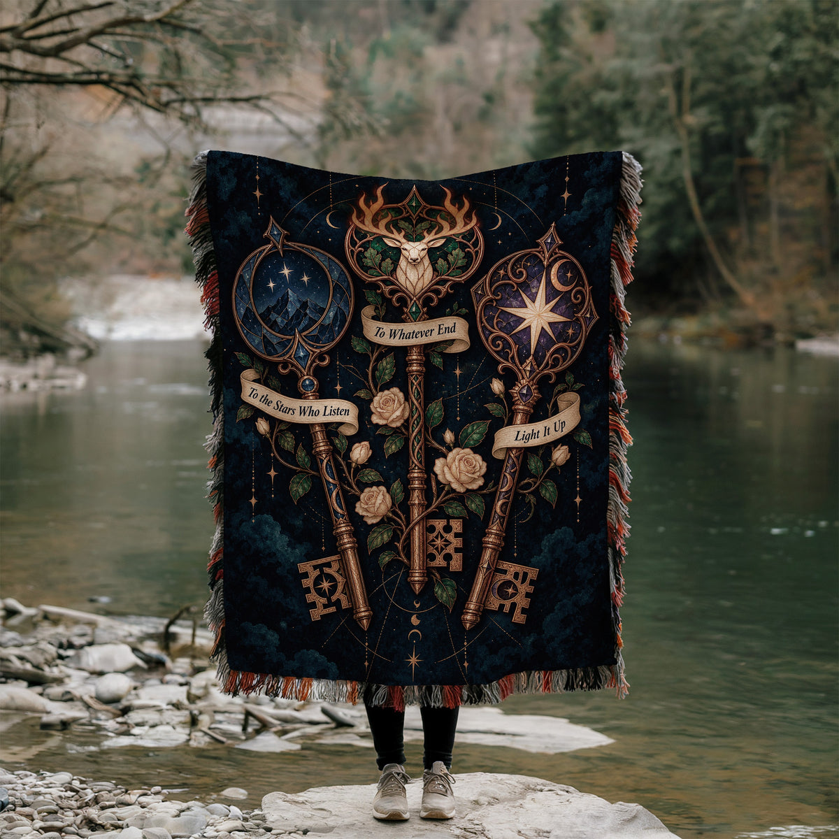 Bookish Maasverse Woven Throw Blanket held up outdoors by a river