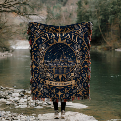 Starfall City of Starlight Crest Woven Throw Blanket held up by a river