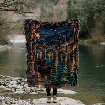 Velaris Woven Throw Blanket held up outdoors by a river