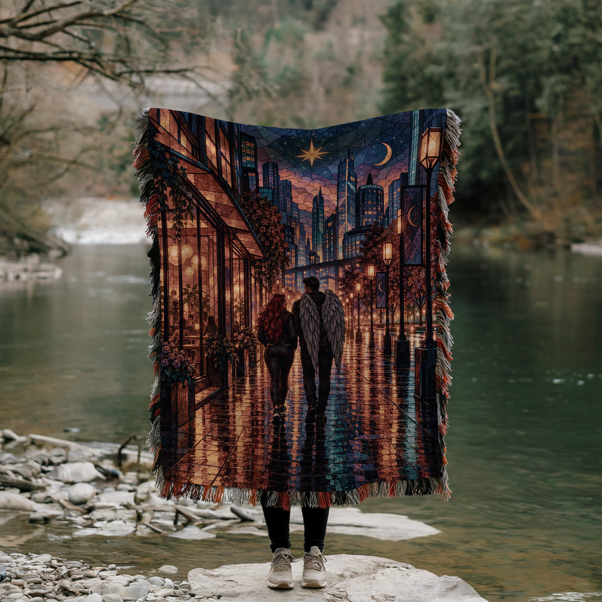 Lunathion Woven Throw Blanket held up outdoors by a river