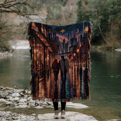 Lunathion Woven Throw Blanket held up outdoors by a river