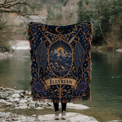 Illyrian Crest Woven Throw Blanket held up by a river