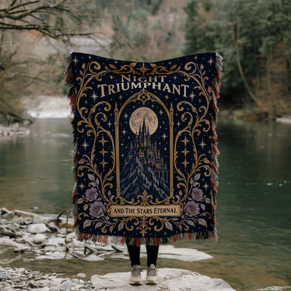 Night Triumphant Crest Woven Throw Blanket held up by a river