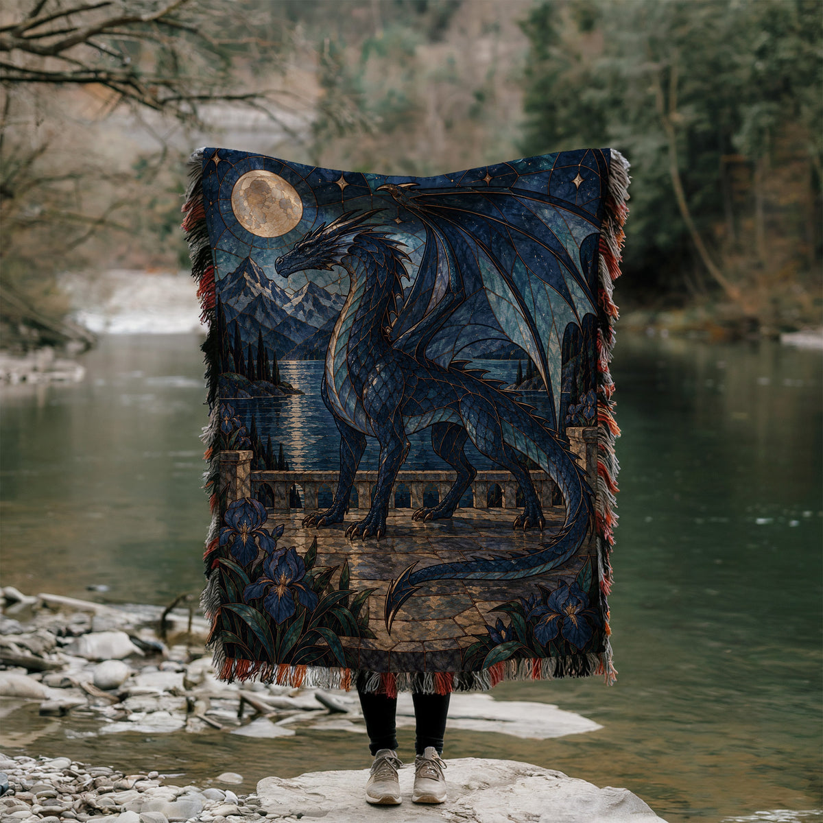 Sgaeyl Woven Throw Blanket held up outdoors by a river