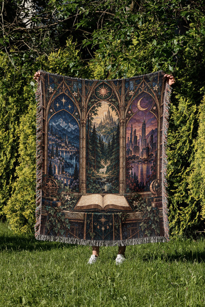 Maasverse Realms Woven Throw Blanket held up in a garden