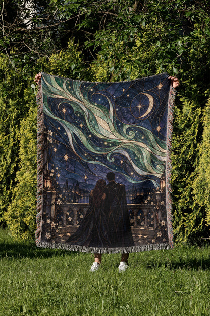 Starfall Stained Glass Woven Throw Blanket held up in a garden