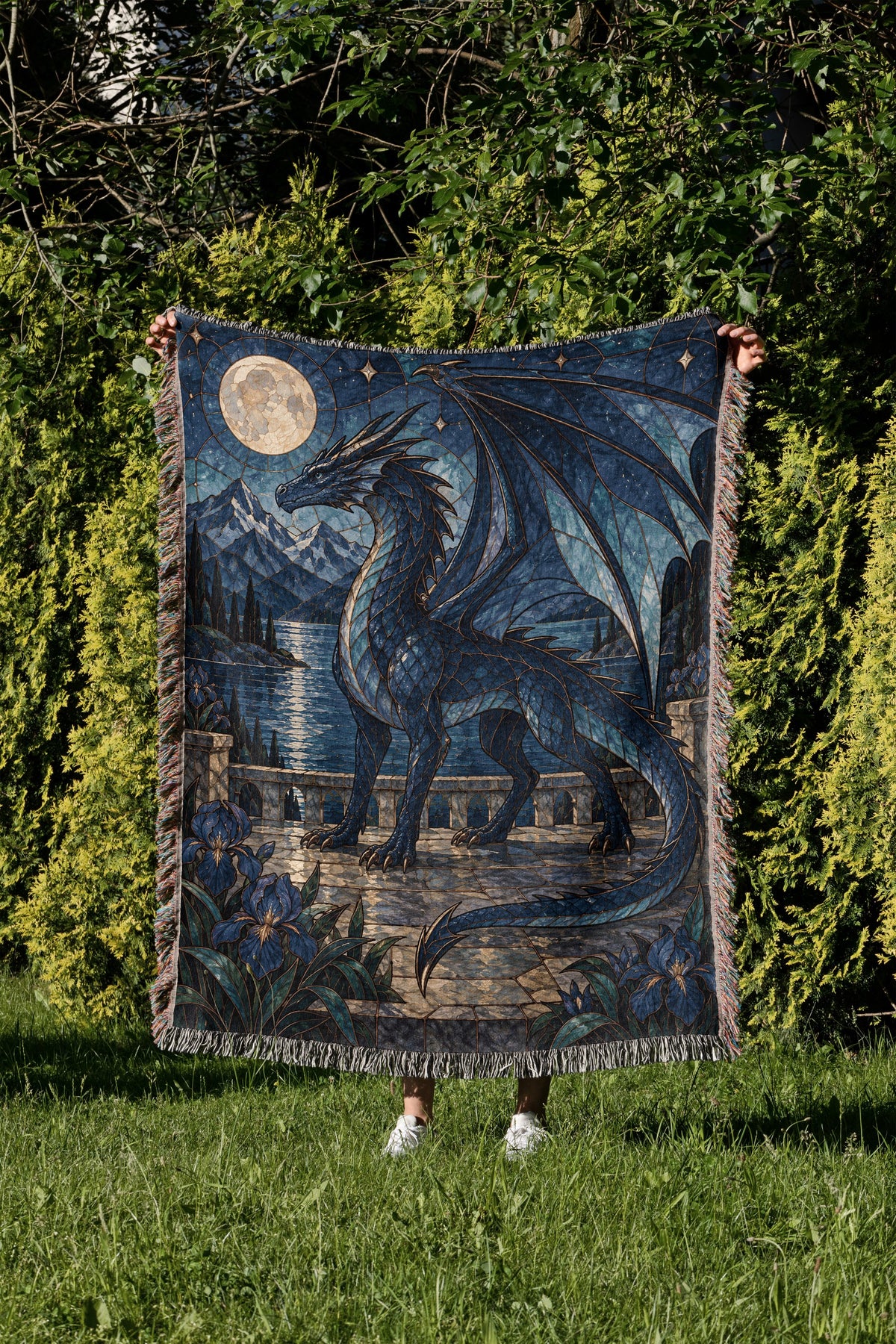 Sgaeyl Woven Throw Blanket held up in a garden