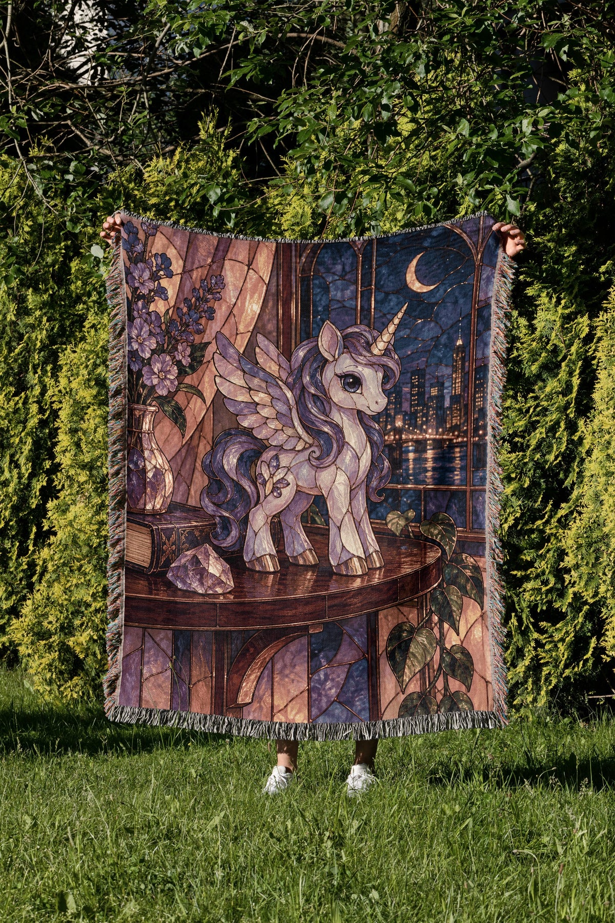 Pegasus Woven Throw Blanket held up in a garden