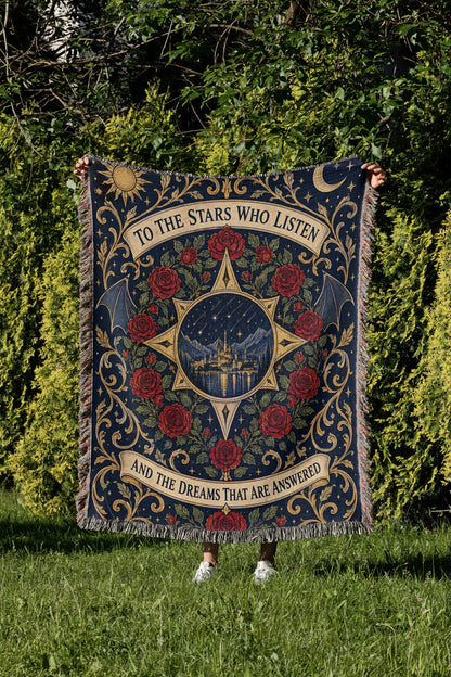 To The Stars Who Listen Rose Crest Woven Throw Blanket held up in a garden