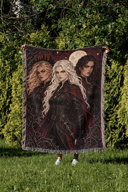 Ice, Fire, and Stone Woven Throw Blanket held up in a garden