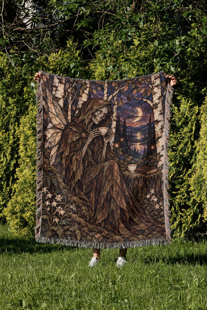 Suriel Tea Woven Throw Blanket held up in a garden
