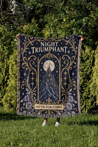 Night Triumphant Crest Woven Throw Blanket held up in a garden