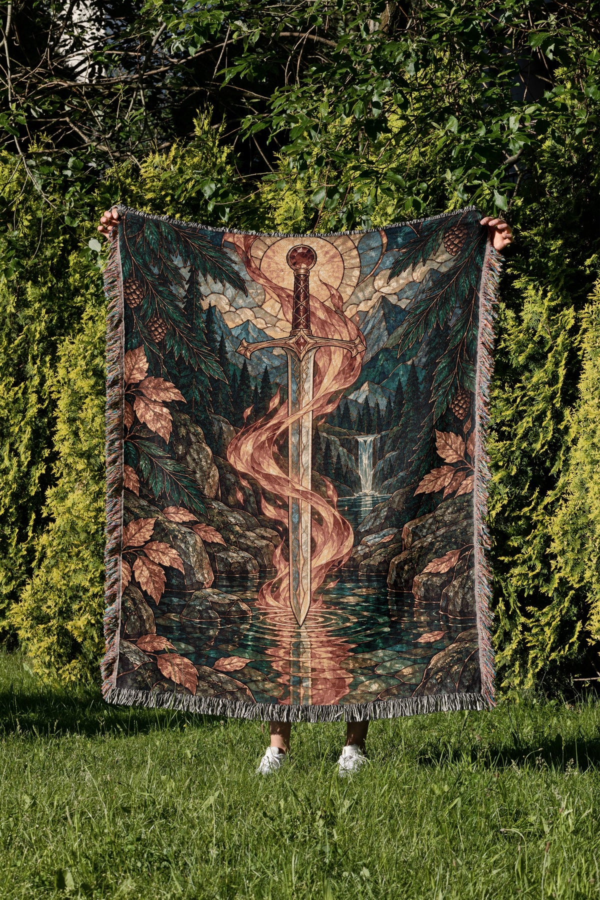Goldryn Woven Throw Blanket held up in a garden