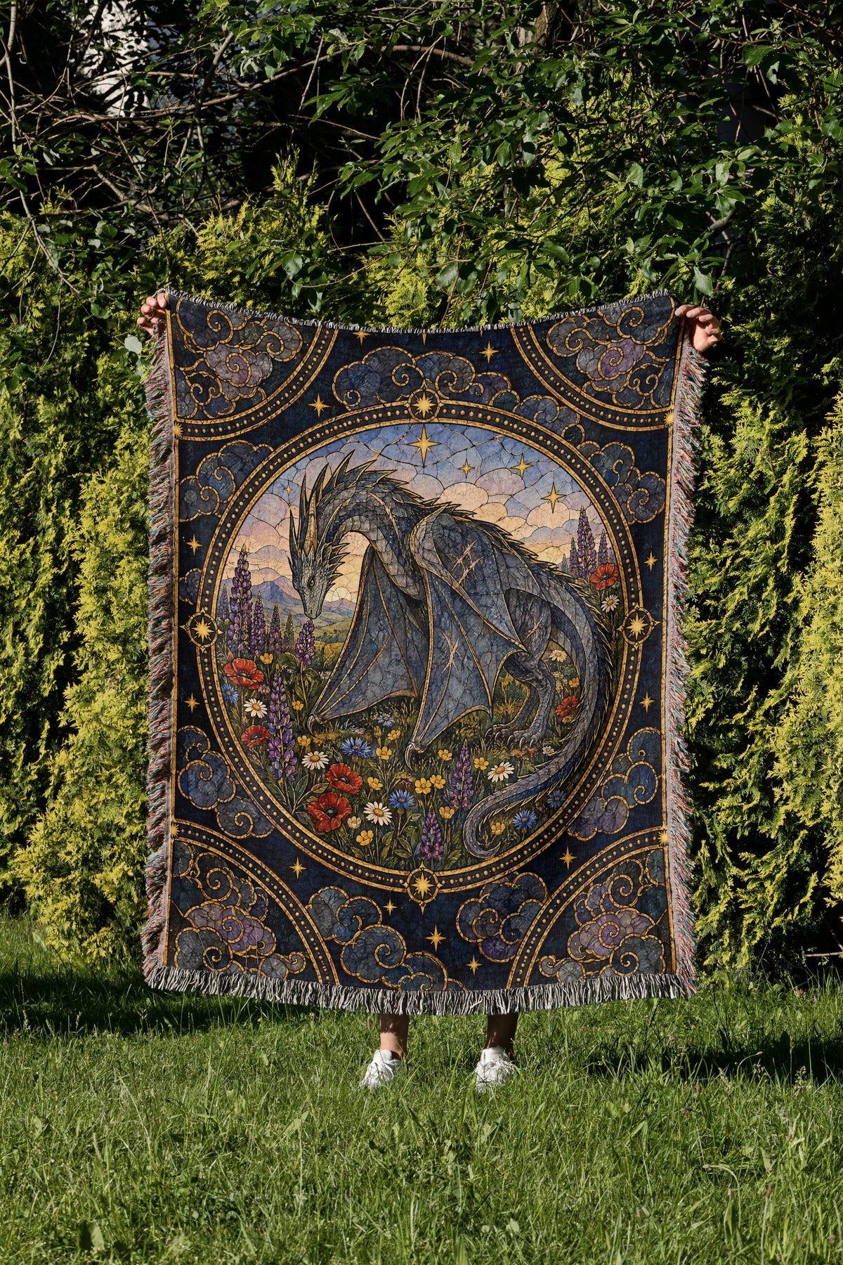 Abraxos in Bloom Stained Glass Woven Throw Blanket held up in a garden