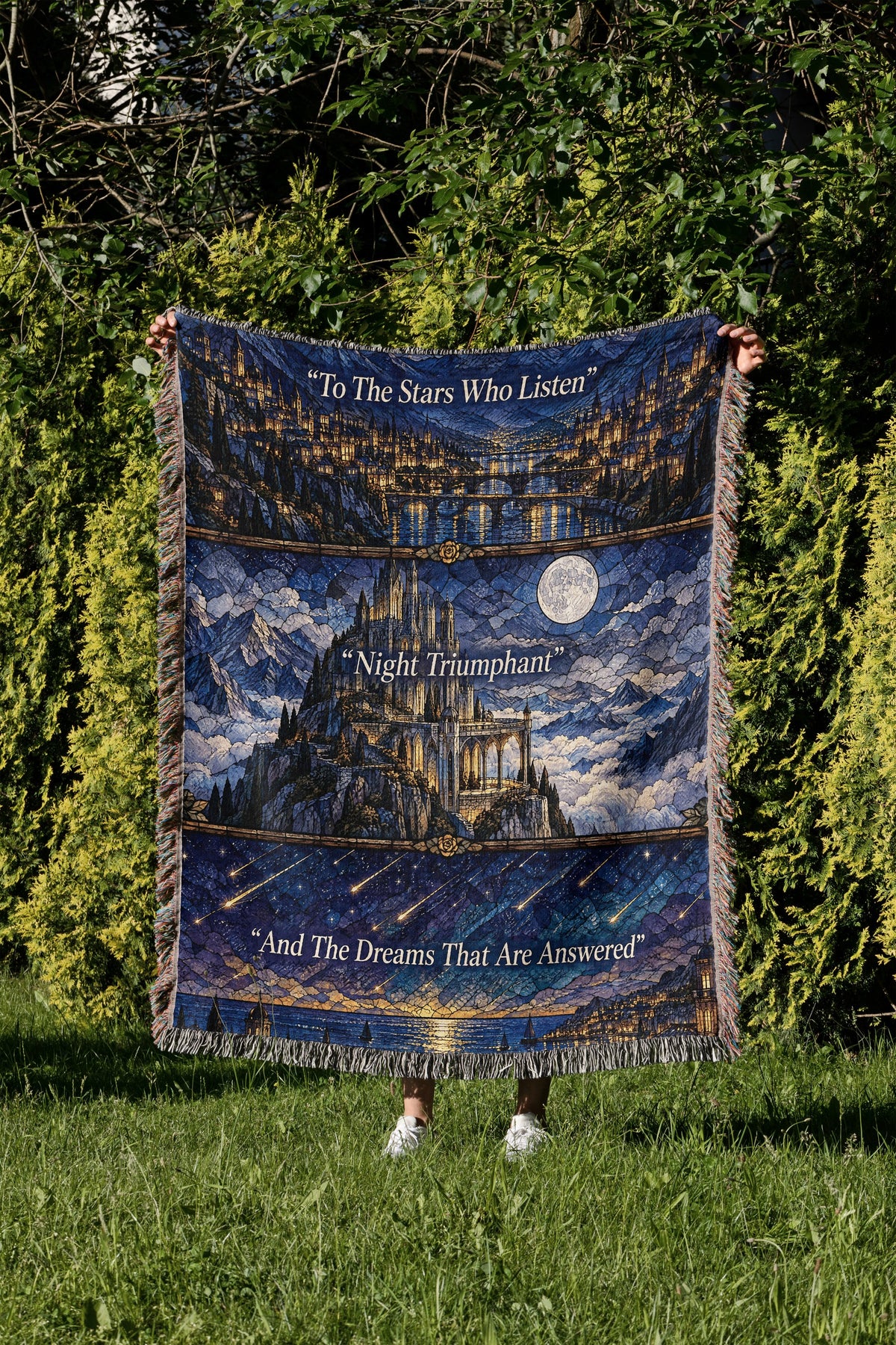 Night Court Stained Glass Woven Throw Blanket held up in a garden