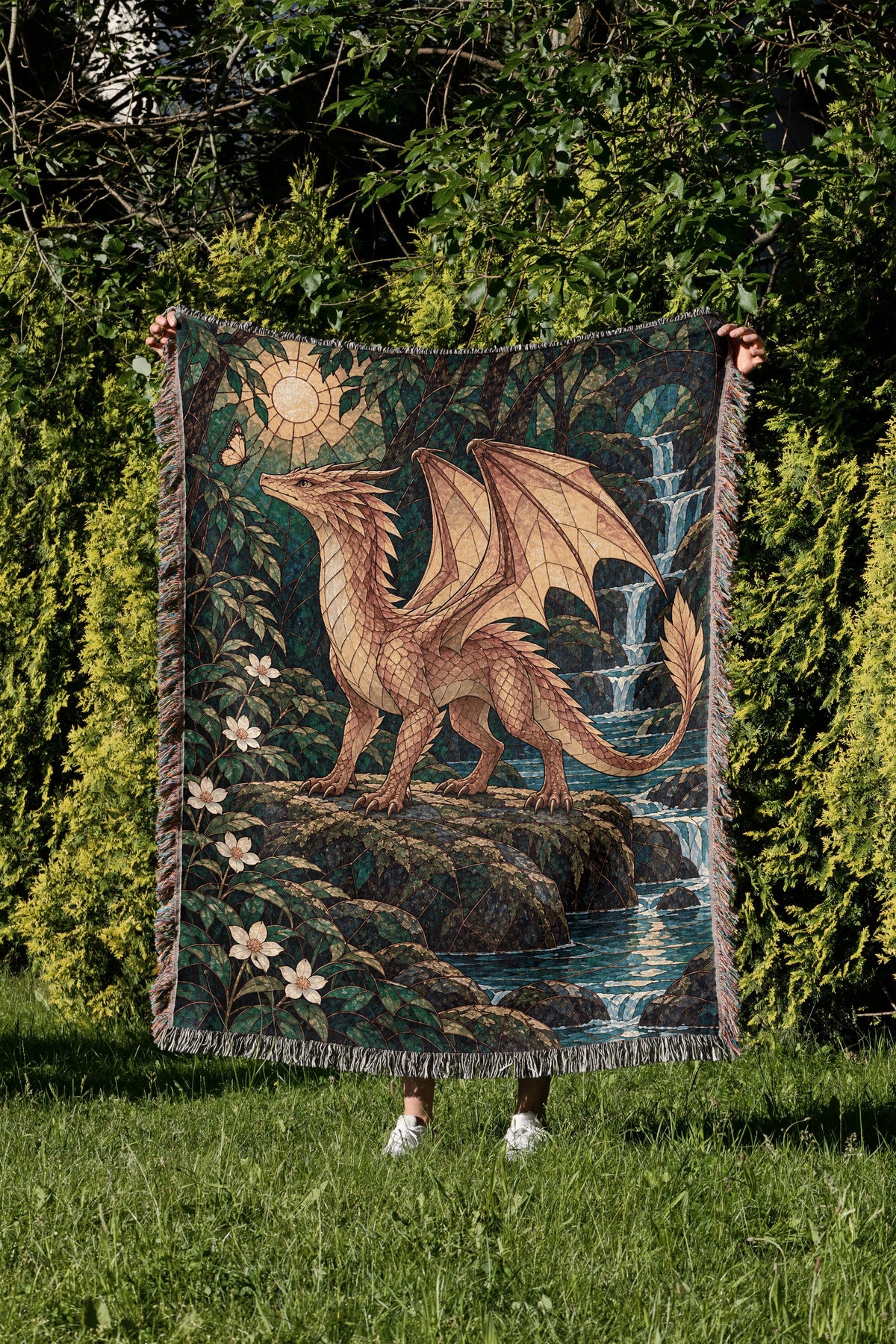 Gold Andarna Woven Throw Blanket held up in a garden