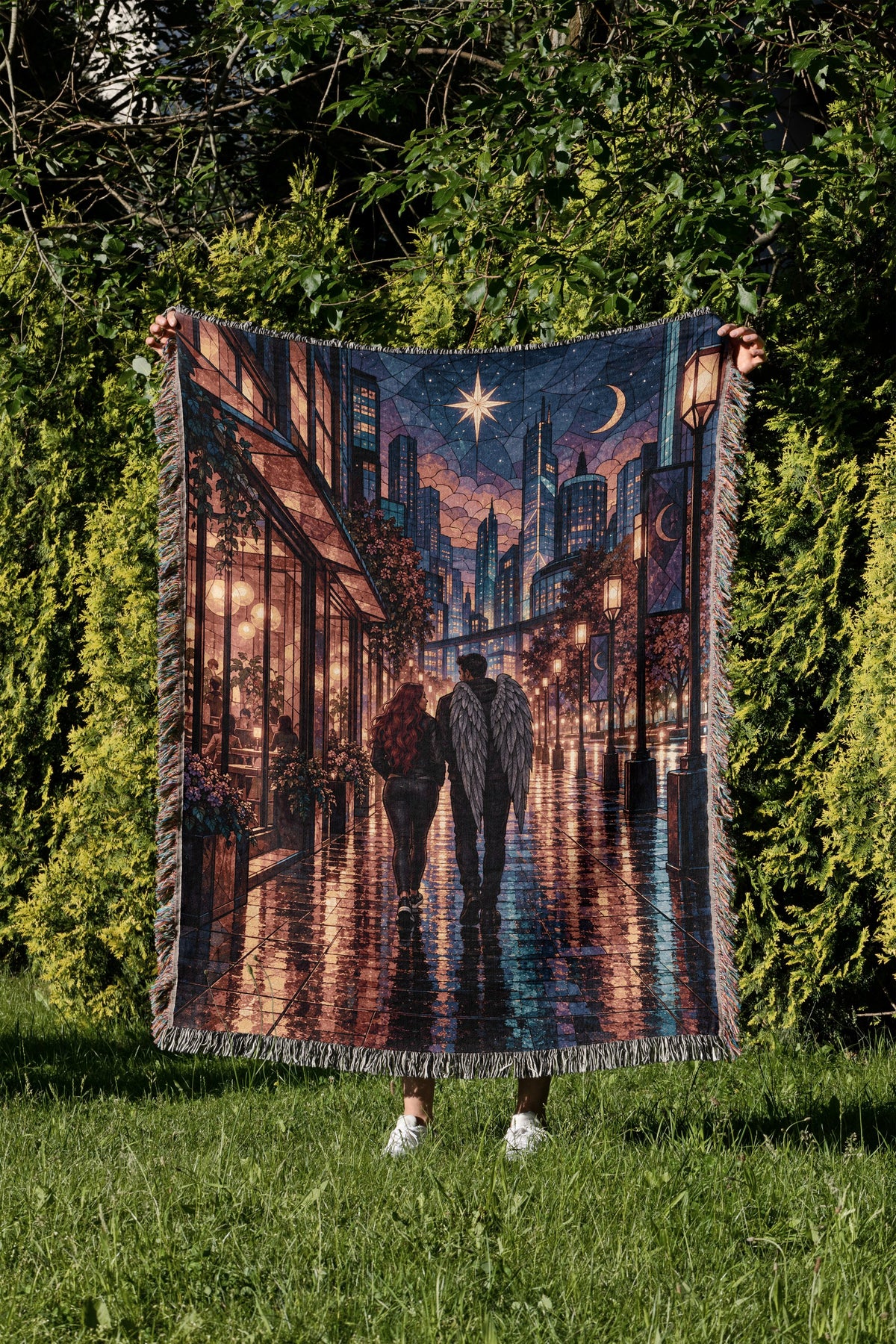 Lunathion Woven Throw Blanket held up in a garden