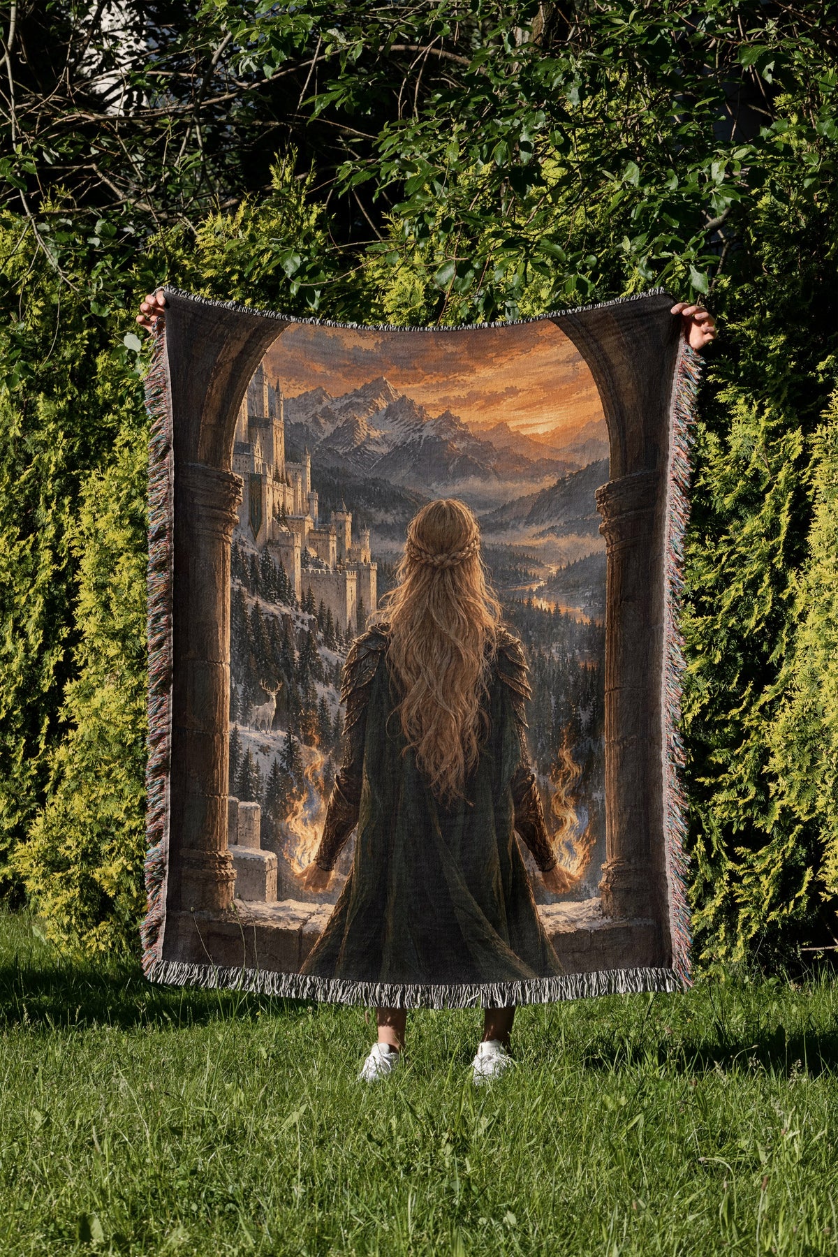 Aelin on the Walls of Orynth Woven Throw Blanket held up in a garden