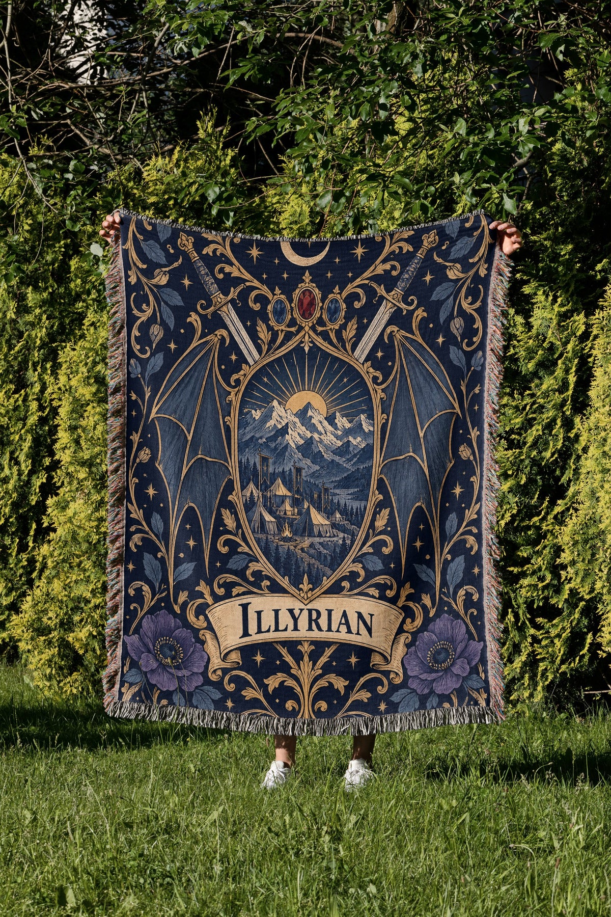 Illyrian Crest Woven Throw Blanket held up in a garden