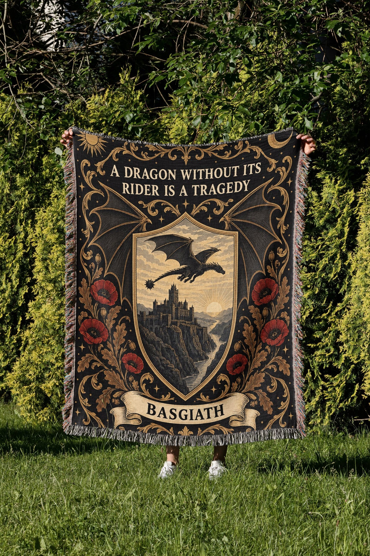Basgiath Dragon Rider Crest Woven Throw Blanket held up in a garden