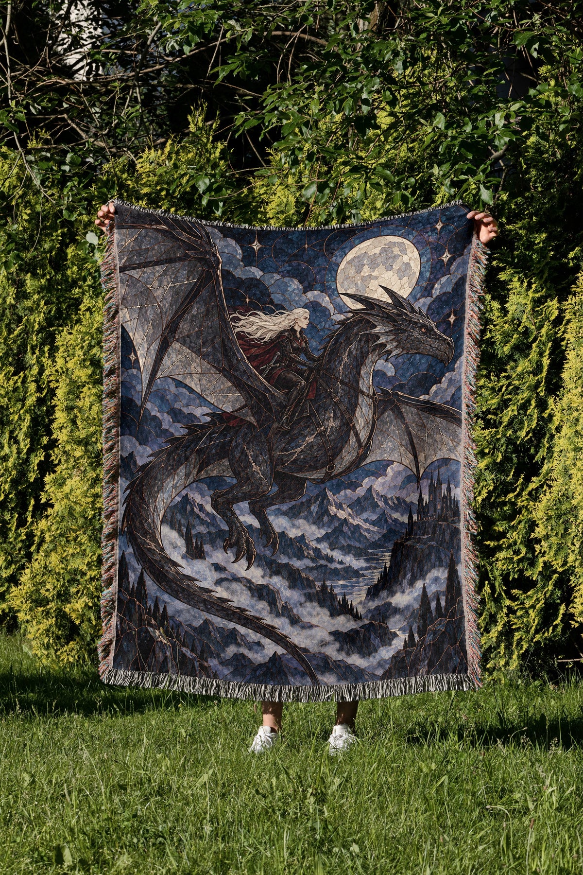 Above the Storm Woven Throw Blanket held up in a garden
