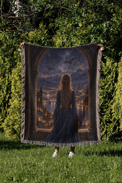 Feyre over Velaris Woven Throw Blanket held up in a garden