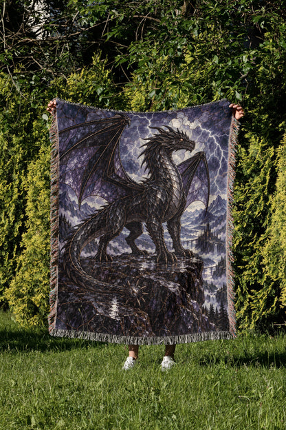 Storm Tairn Woven Throw Blanket held up in a garden