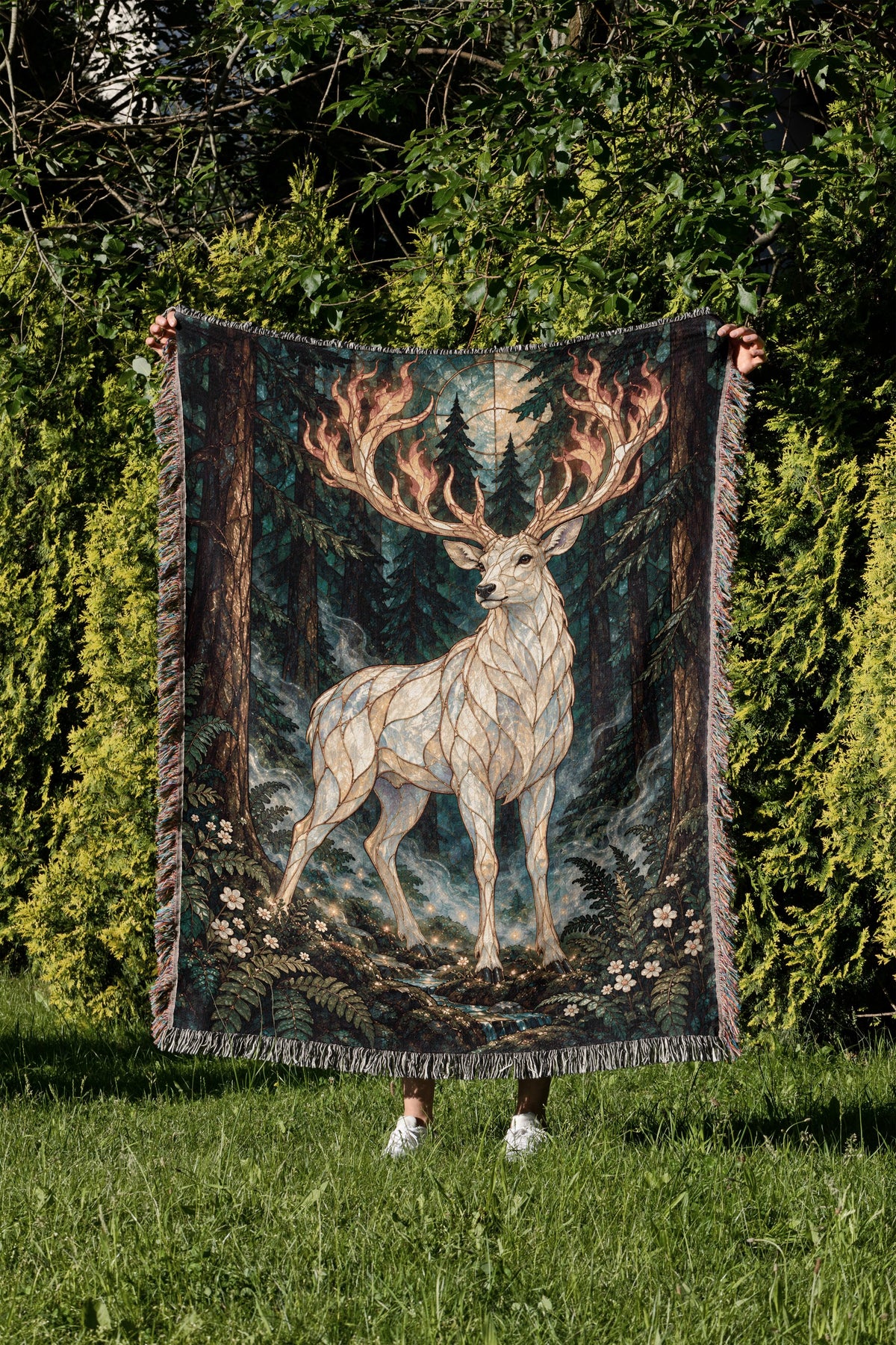 Terrasen Stag Woven Throw Blanket held up in a garden