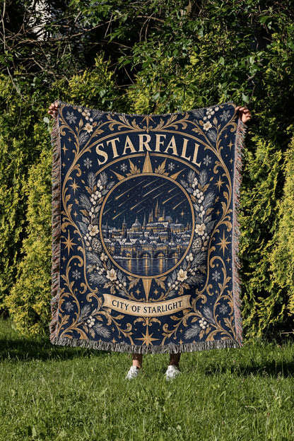 Starfall City of Starlight Crest Woven Throw Blanket held up in a garden