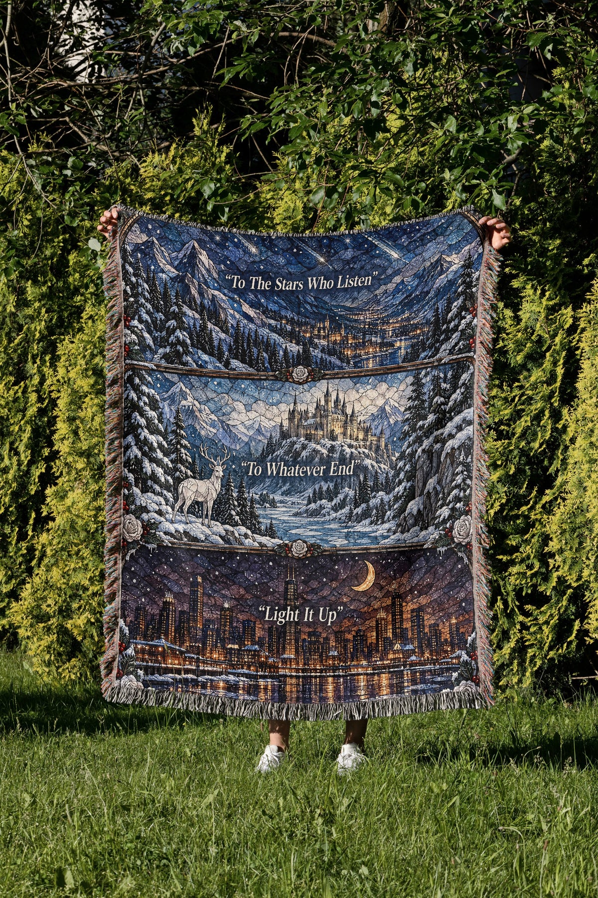 Winter Maasverse Stained Glass Woven Throw Blanket held up in a garden