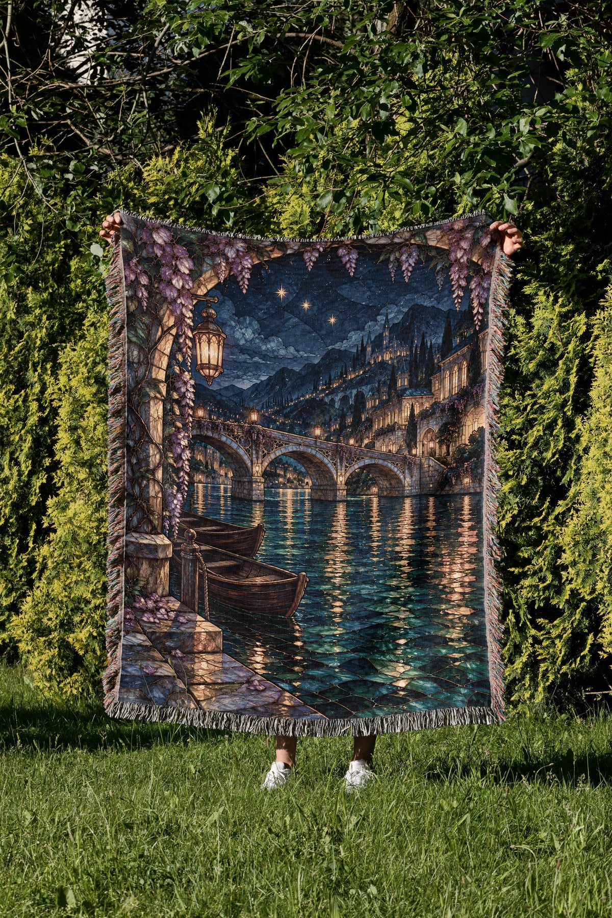 Velaris Woven Throw Blanket held up in a garden