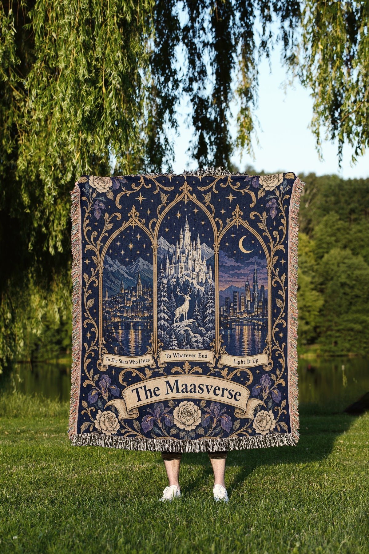 Maasverse Three Realms Crest Woven Throw Blanket held up outdoors