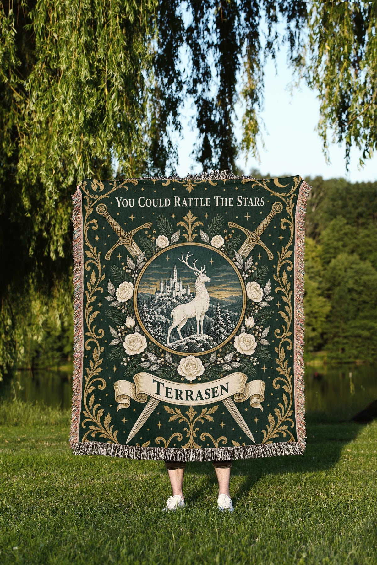 Terrasen Crest Woven Throw Blanket held up outdoors