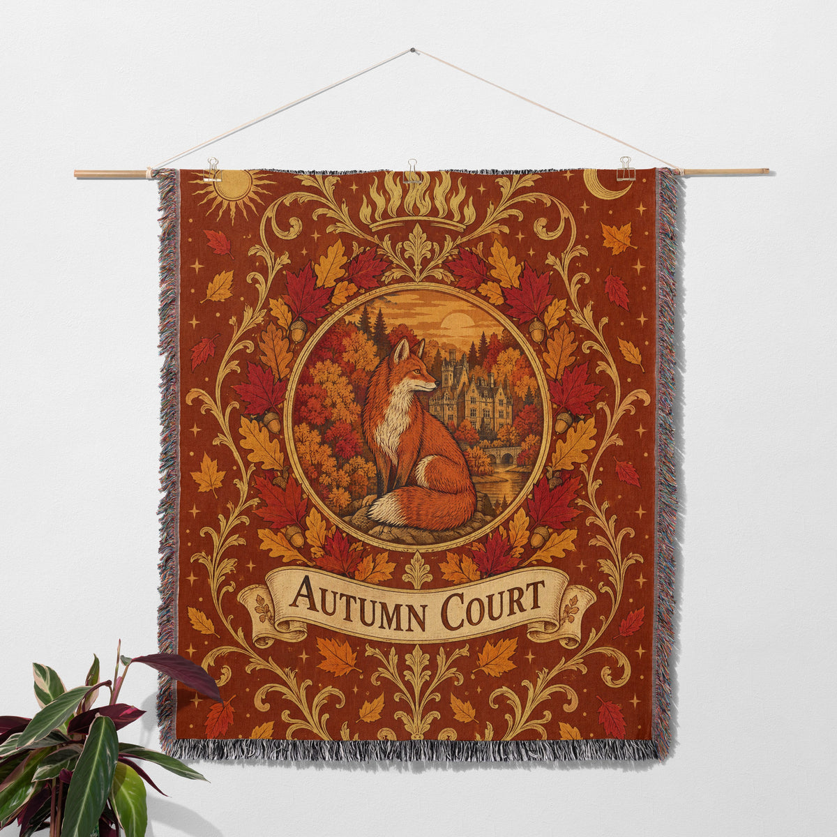 Autumn Court Fox Crest Woven Throw Blanket hanging on a wall with a plant