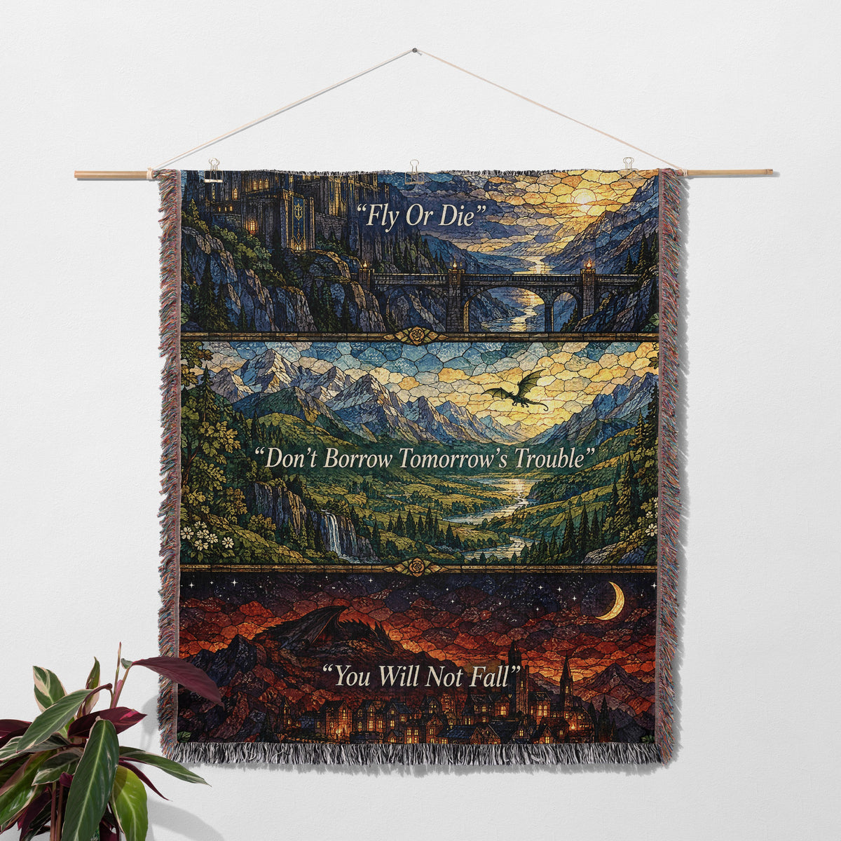 Empyrean Stained Glass Woven Throw Blanket hanging on a wall with a plant
